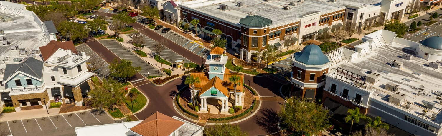 Aerial view of a clock tower roundabout and shops in Winter Garden, Florida